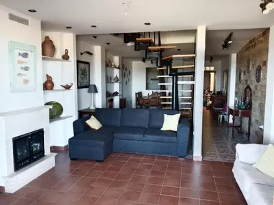 a living room with a blue couch and a fireplace at Els Vents primera línea playa Puçol in Puzol