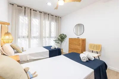 a bedroom with two beds and a window at Travel Habitat - Apartamento Familiar & Espacioso de 3 Dormitorios in Valencia
