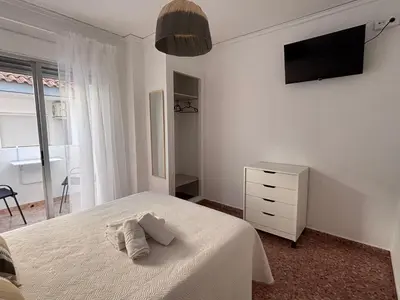 a bedroom with a bed with two towels on it at VMC Rooms in Tavernes de Valldigna