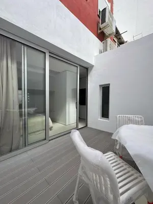 a balcony with a table and chairs and a bedroom at Superloft in Burjasot