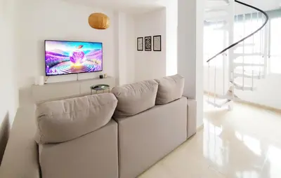 a living room with a couch and a flat screen tv at Pet Friendly Home In Puerto De Sagunto in Puerto de Sagunto