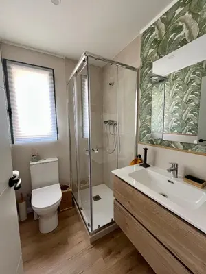 a bathroom with a shower and a toilet and a sink at Casa Hoyo 19 in Masía Aldamar