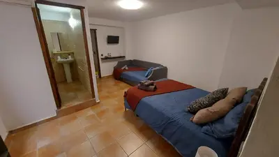 a room with a bed and a couch in it at Las Anas Rural in Cortez de Pallas