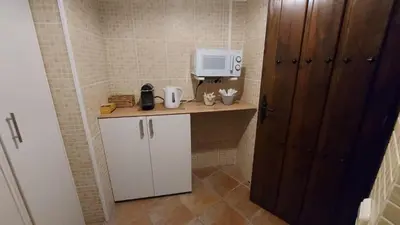 a small kitchen with a counter with a coffee maker at Las Anas Rural in Cortez de Pallas