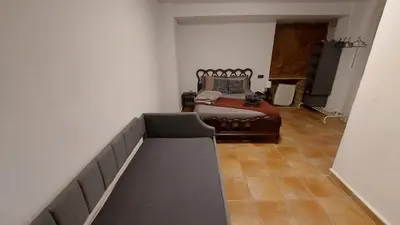 a bedroom with a bed and a couch at Las Anas Rural in Cortez de Pallas