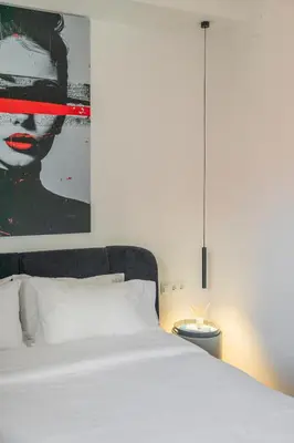 a bedroom with a white bed and a large painting at Valencia Beach Luxury Penthouse, Late Checkout in Valencia