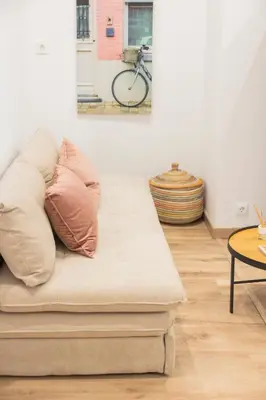 a couch with pillows on it in a living room at Luxury apartament, close to Cabañal Beach, Late Checkout in Valencia