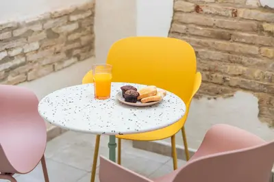 a table with a plate of food and a glass of orange juice at Luxury apartament, close to Cabañal Beach, Late Checkout in Valencia