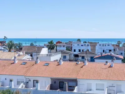 a group of houses with the ocean in the background at Winahost Apartment Neo Residencial Mediterráneo in Barrio-Mar