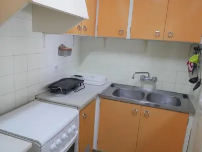 a small kitchen with a sink and a stove at Levante, 1-N in Cullera