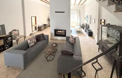 a living room with a couch and a fireplace at Gorgeous Home In Llaurí With Wifi in Llaurí