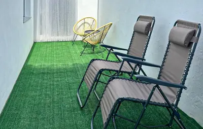 a room with chairs and a green floor at Gorgeous Home In Llaurí With Wifi in Llaurí