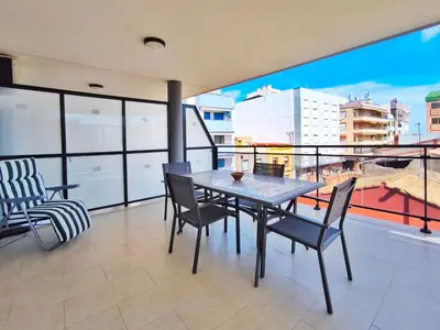 a dining room with a table and chairs on a balcony at Apartamento con Terraza junto al Mar en Moncofa in Moncófar