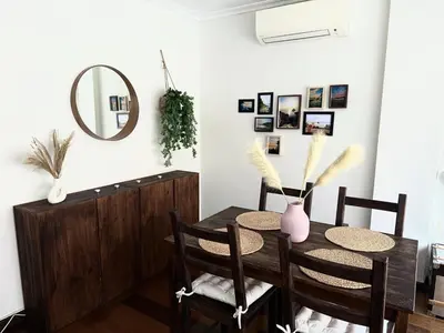 a dining room with a table and a mirror at Apartment 100m from the beach in Cullera