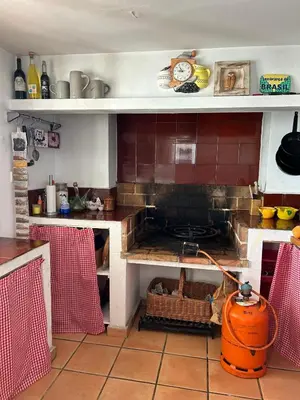 a kitchen with a stove top oven in a kitchen at Vila 
