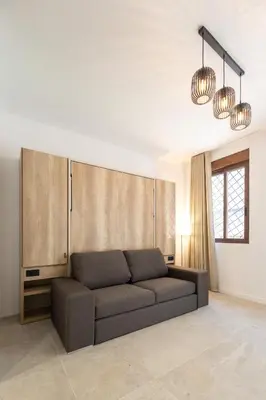 a living room with a couch and two lights at Arm Suites by Concept Flats in Valencia