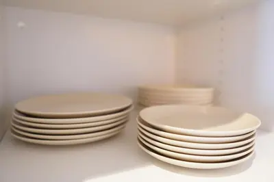 a stack of white plates sitting on a table at Premium & Céntrico in Valencia