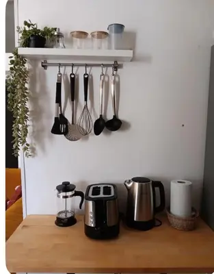 a shelf with utensils on a wall at Sueños en la playa in Valencia