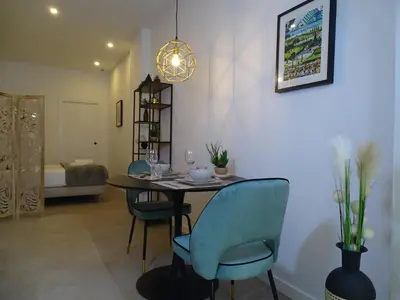 a dining room table with chairs and aendant light at MDB 52A - Loft Valencia in Valencia
