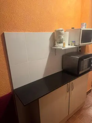a kitchen with a counter top with a microwave at Apartamento en el faro de Cullera in Cullera