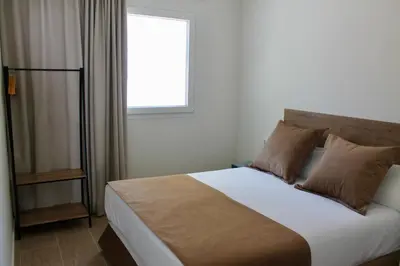 a bedroom with a large bed with a window at Maresia Zarco in Valencia
