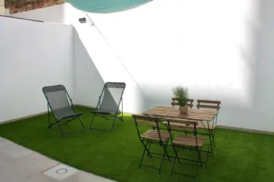 a room with a table and chairs with green grass at Maresia Zarco in Valencia