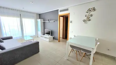 a living room with a couch and a table at BEACH VALENCIA LUXURY D9-28 Apartment with terrace and sea views with two rooms in Valencia
