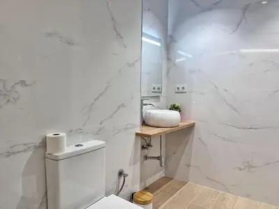 a white bathroom with a toilet and a sink at Loft Familiar: Paz y Conexión Ideal en Valencia in Valencia