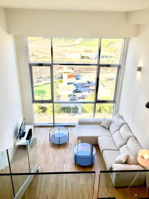 a living room with a white couch and a large window at Panoramic Suites II By VALENCIAFLATS EU in Valencia