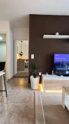 a living room with a tv on a brown wall at Apartamento en Canet De Berenguer Playa - Valencia in Valencia