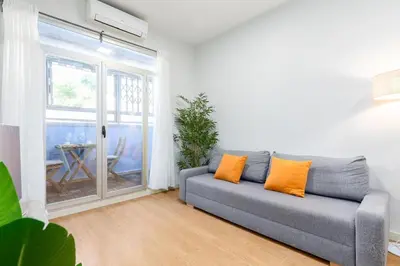 a living room with a couch and a large window at Beachside Apartment Valencia Ideal for Digital Nomads in Valencia