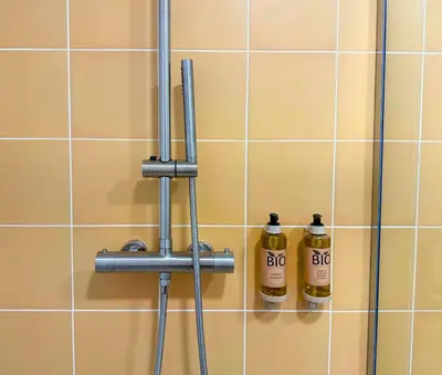 two bottles of fire extinguishers on a tiled wall at Design and style next to Playa de Valencia in Valencia