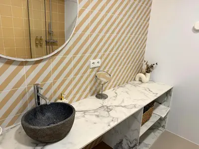 a bathroom with a sink and a mirror at Design and style next to Playa de Valencia in Valencia