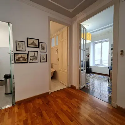 an empty room with a hallway with wooden floors and white walls at The Plaza Residence in Valencia