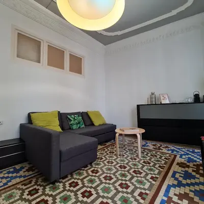 a living room with a couch and a table at The Plaza Residence in Valencia