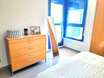 a bedroom with a dresser and a bed and a window at BEACH VALENCIA LUXURY D15-21 Apartment with terrace and sea views with two rooms in Valencia