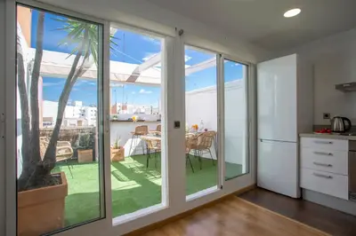 a kitchen with sliding glass doors leading to a patio at SingularStays Plaza Andújar in Valencia
