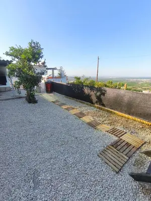 a metal grate on the ground next to a house at Casa en la montaña con jacuzzi exterior y piscina in Alcántara de Júcar