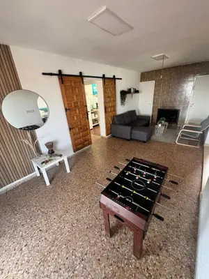 a living room with a couch and a table at Casa en la montaña con jacuzzi exterior y piscina in Alcántara de Júcar