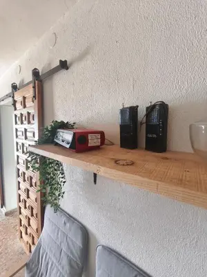a shelf on a wall with a radio on it at Casa en la montaña con jacuzzi exterior y piscina in Alcántara de Júcar