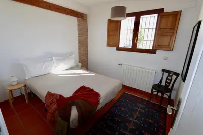 a bedroom with a white bed and a window at Peaceful apartment in Peñalba in Peñalba