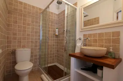 a bathroom with a toilet and a sink and a shower at Peaceful apartment in Peñalba in Peñalba