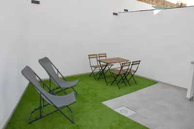 a room with chairs and a table with green grass at Arenisca Zarco in Valencia