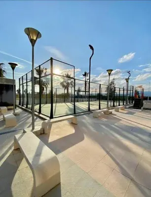 a park with benches and lights and a fence at kalma in Moncófar