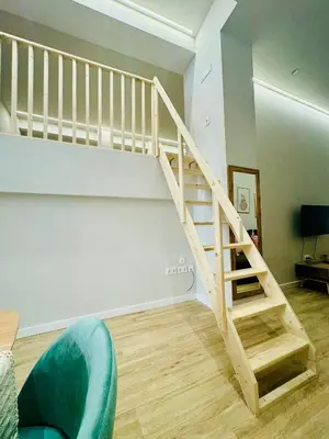 a wooden staircase in a living room with a couch at Modern Apartment with Style near Center in Valencia