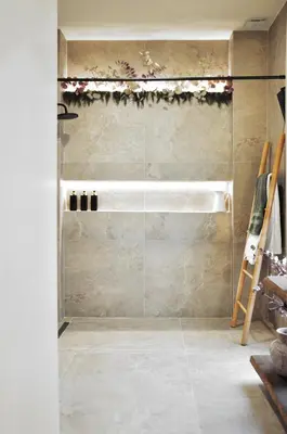 a shower with a glass door in a bathroom at The Robby's home in Valencia