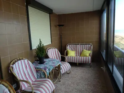 a room with chairs and a table and a table and a window at barlovento in Sueca