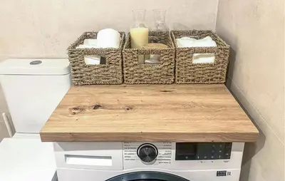 a bathroom with a washing machine with a table on top at Beach Front Apartment In Sagunto in Sagunto