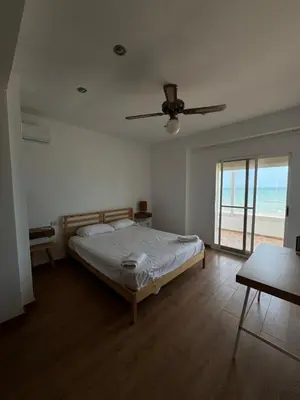 a bedroom with a bed and a ceiling fan at El Encanto del Perelló in Sueca
