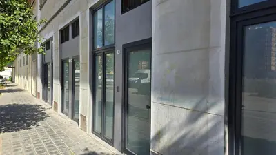 a row of glass doors on the side of a building at Arena Legacy Modern Suits in Valencia